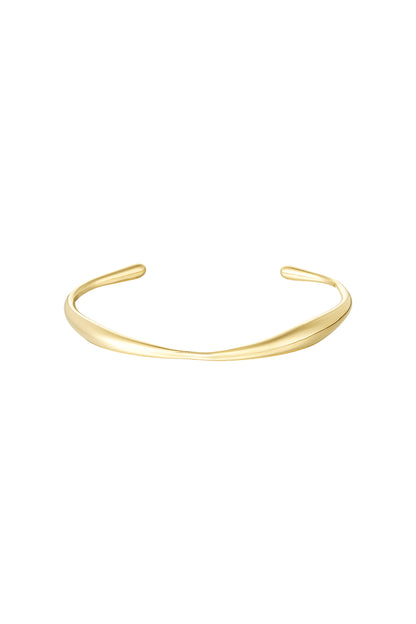 Minimalist gold cuff bracelet with smooth organic curves isolated on white background