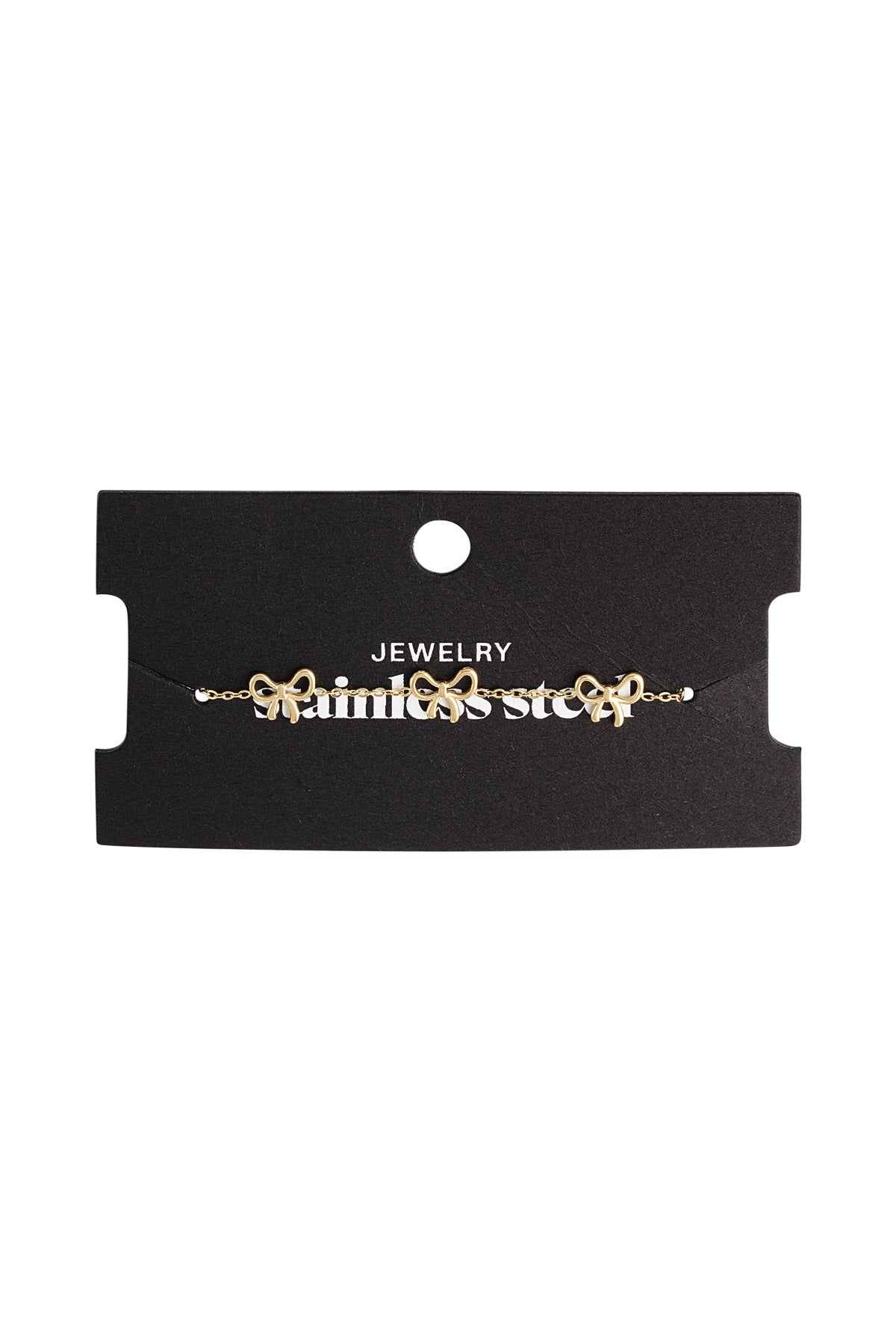 Gold bow charm bracelet displayed on black jewelry card with 'stainless steel' branding