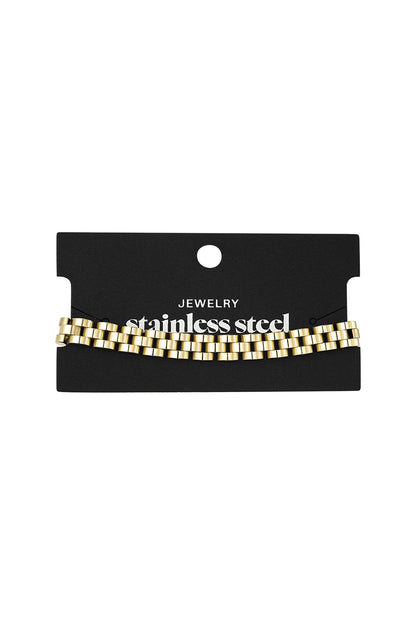 Two-tone gold and silver stainless steel chain bracelet displayed on branded card