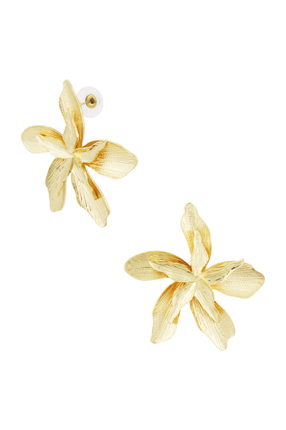Close-up of gold flower-shaped stud earrings showing detailed textured petals on white background