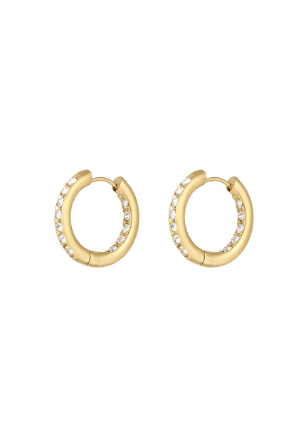 Pair of gold-tone stainless steel hoop earrings adorned with clear rhinestones on a white background