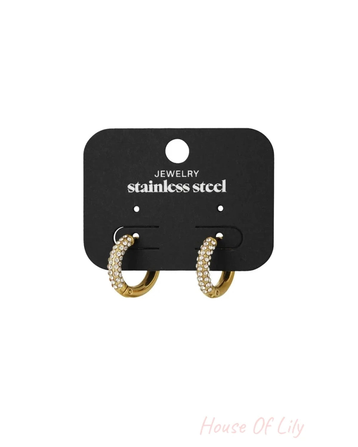 Gold hoop earrings encrusted with small clear crystals, displayed on a black stainless steel display card.