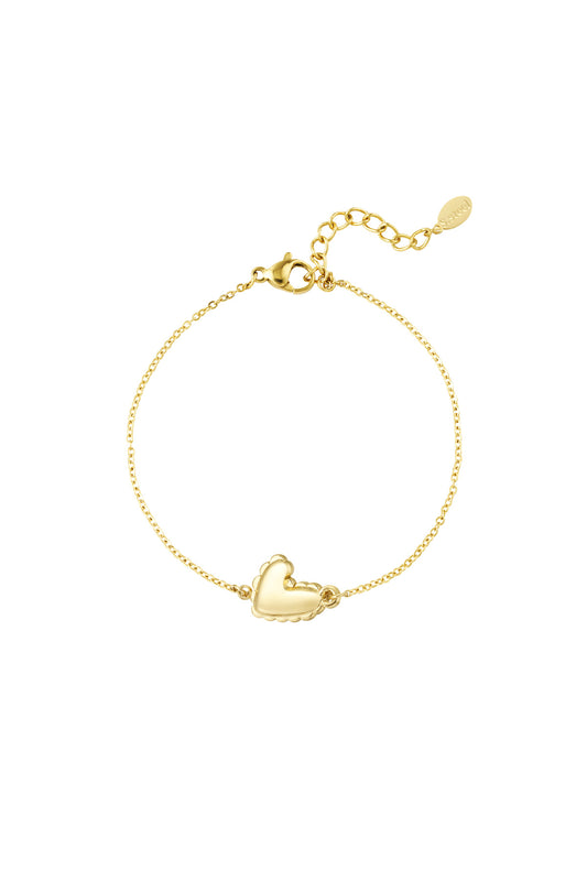 Gold heart detail bracelet with scalloped edges and adjustable chain on white background