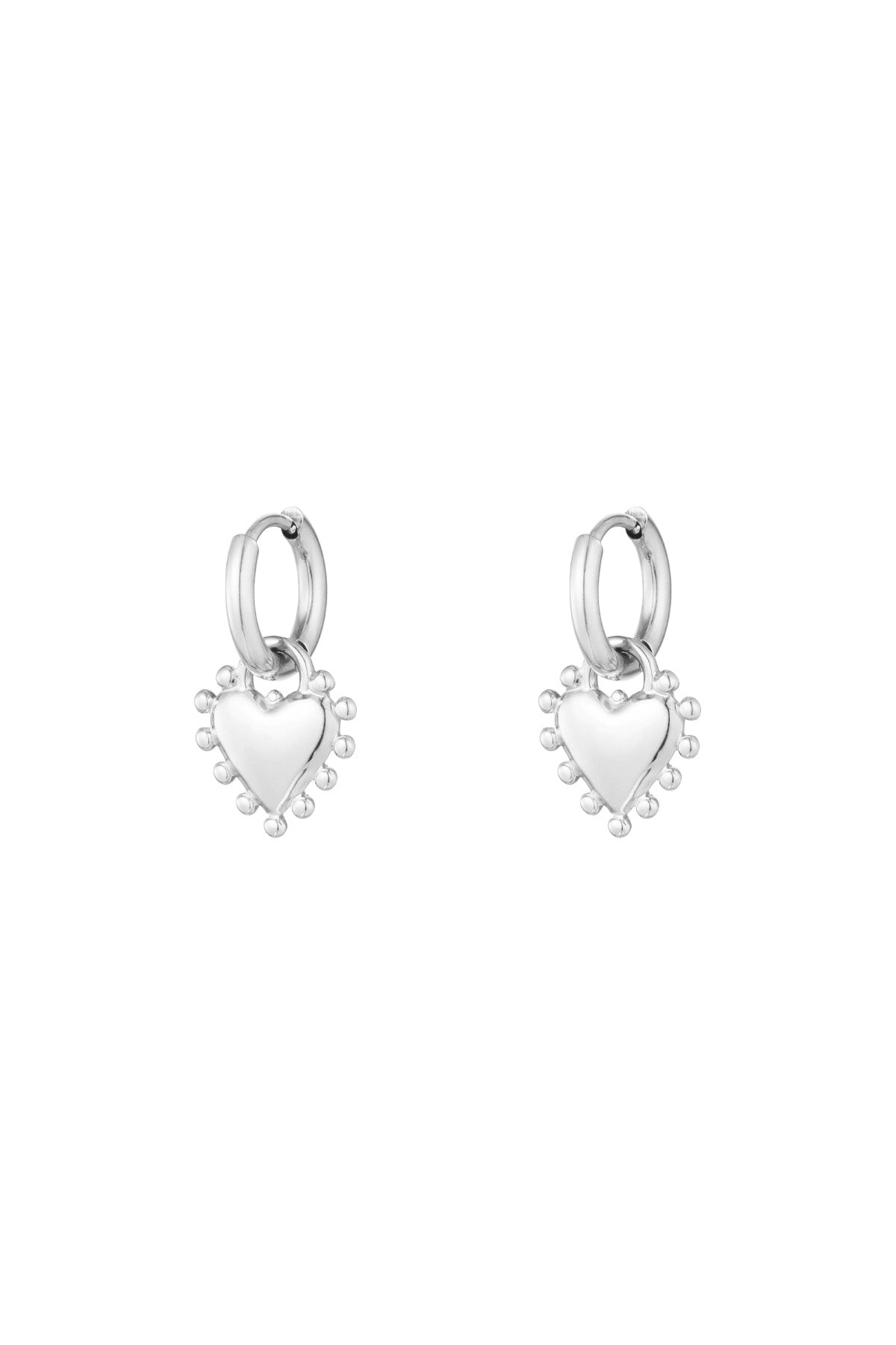 Pair of silver heart charm hoop earrings with beaded edge detail on white background