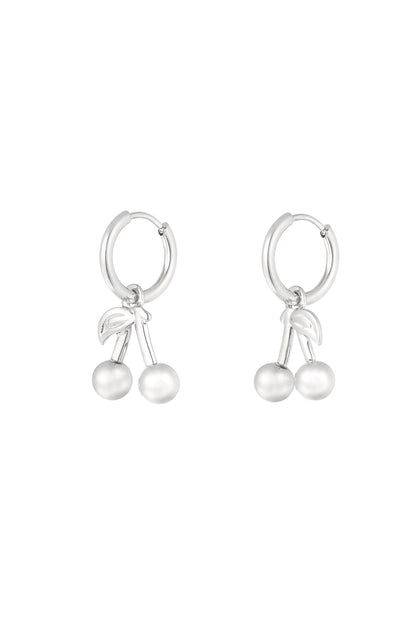 Silver-tone hoop earrings with cherry-shaped dangling charms made of stainless steel on a white background