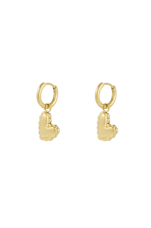 Close-up of gold heart charm drop earrings with scalloped puffed heart design against white background
