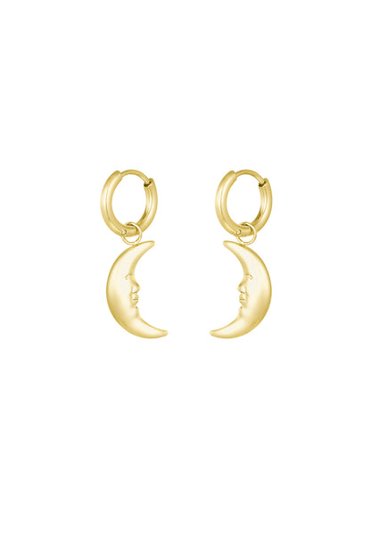 Pair of gold crescent moon face dangling hoop earrings on white background