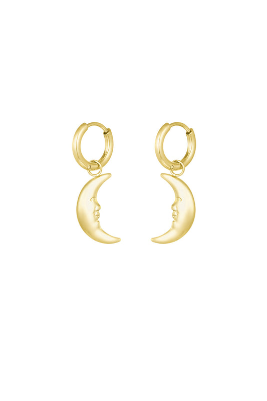 Pair of gold crescent moon face dangling hoop earrings on white background