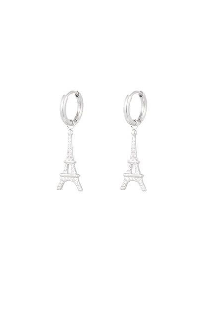 Pair of silver Eiffel Tower drop earrings on white background
