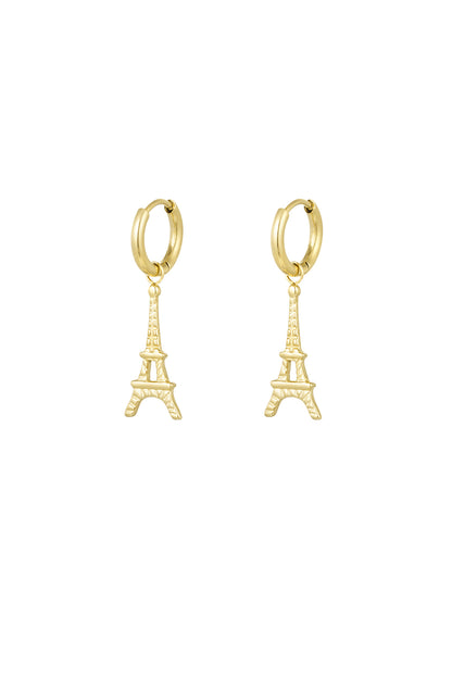 Pair of gold Eiffel Tower drop earrings on white background