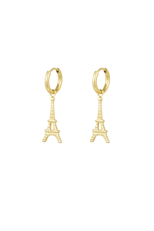 Pair of gold Eiffel Tower drop earrings on white background