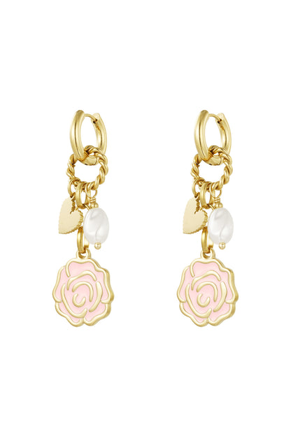 Pair of gold-tone drop earrings with pastel pink enamel rose, faux pearl and heart charms on white background