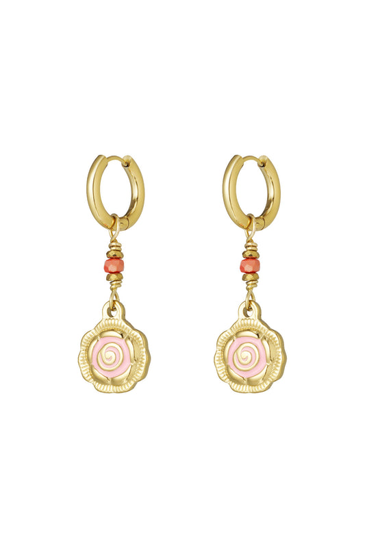 Pair of gold-tone hoop earrings with dangling spiral flower charms in pink and coral beads on white background