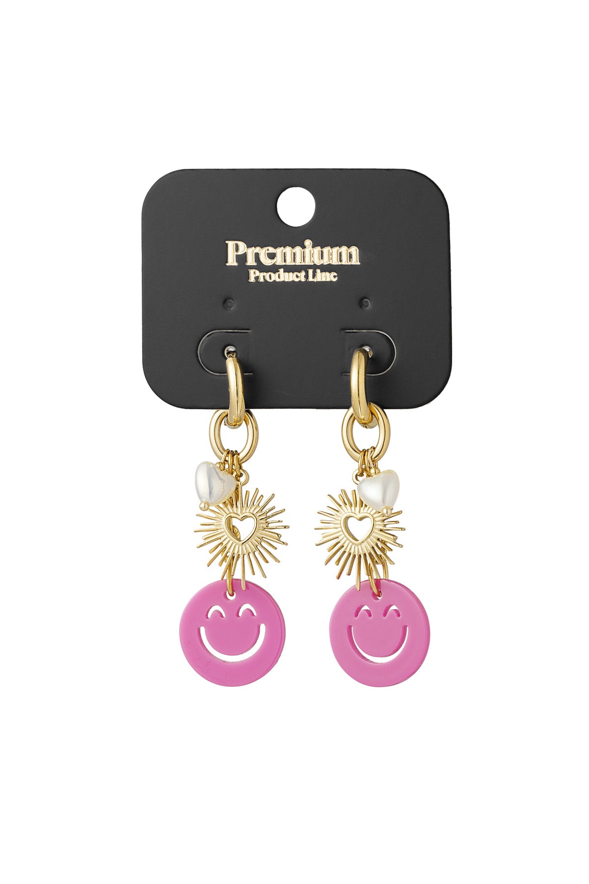Gold drop earrings with smiley pink charm, sunburst heart, and pearl heart displayed on a black Premium Product Line card