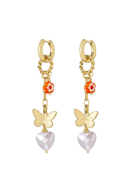 Gold drop earrings with orange flower, butterfly charm, and faceted light pink heart pendant on white background