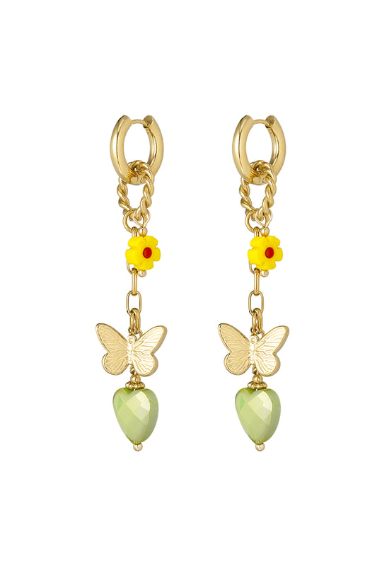 Gold drop earrings with yellow flower, butterfly charm, and faceted light green heart pendant on white background