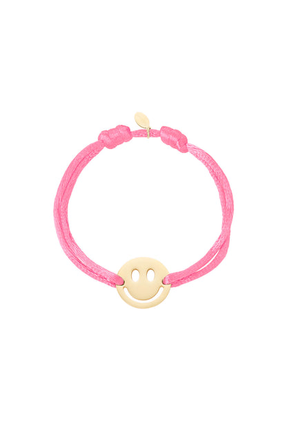 Grey satin cord bracelet with gold-tone smiley face charm on white background