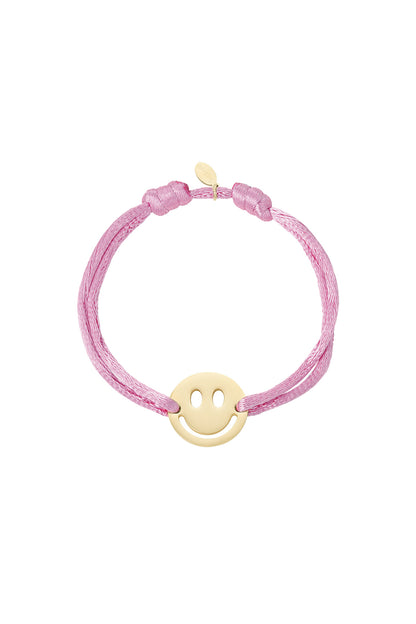 Brown satin cord bracelet with gold-tone smiley face charm on white background