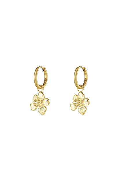 Pair of gold hoop earrings each with a dangling detailed flower charm on a white background