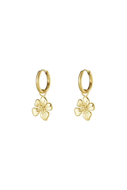 Pair of gold hoop earrings each with a dangling detailed flower charm on a white background