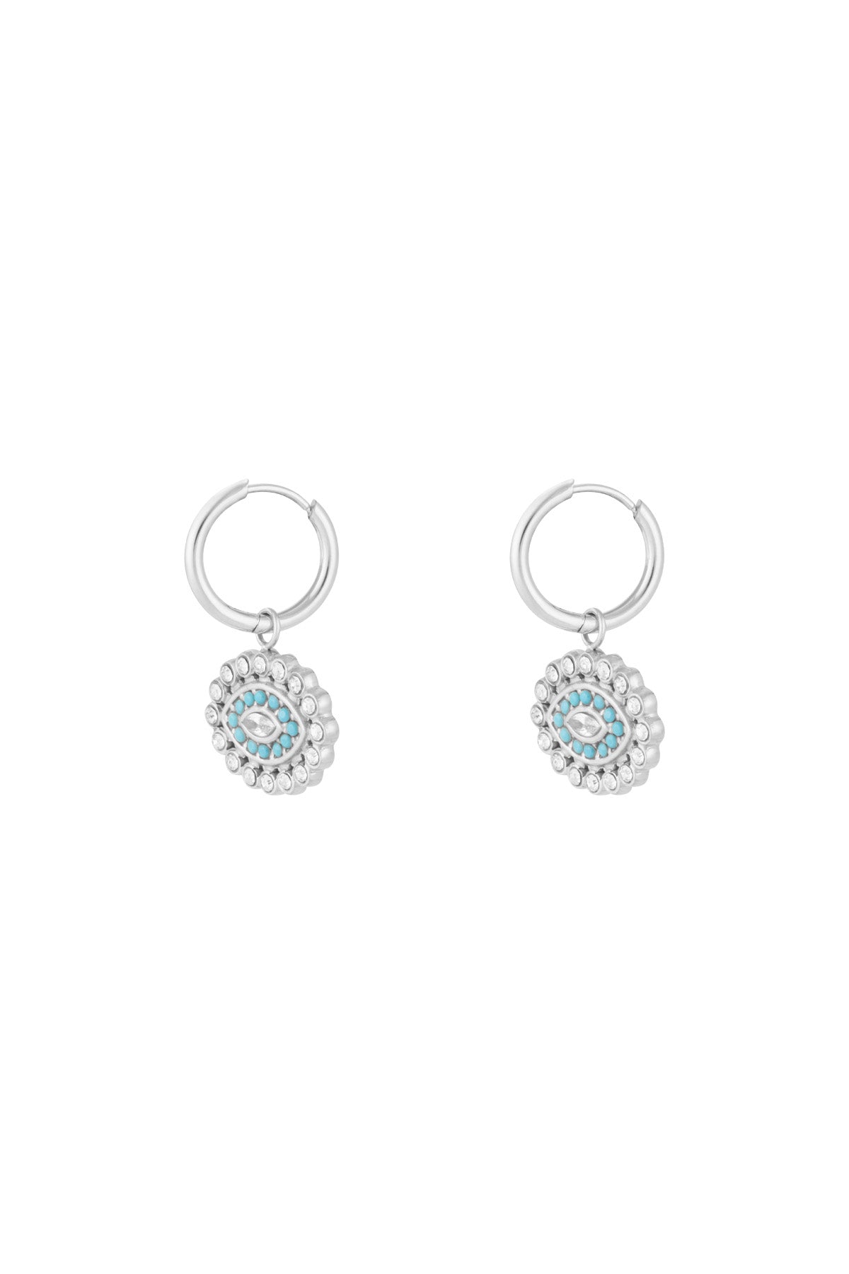 Silver stainless steel hoop earrings with dangling turquoise and rhinestone evil eye charms on white background