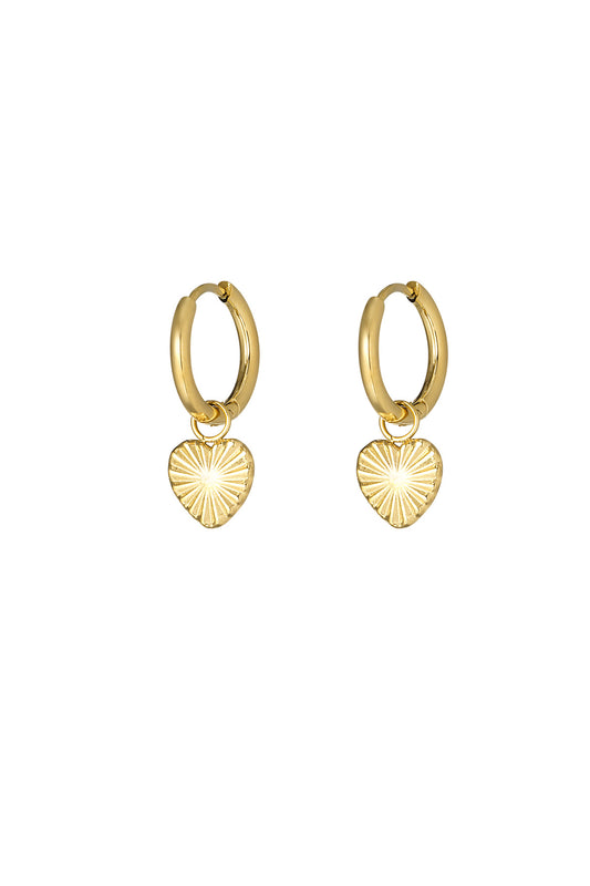 Gold hoop earrings featuring embossed sunburst heart charms on a white background