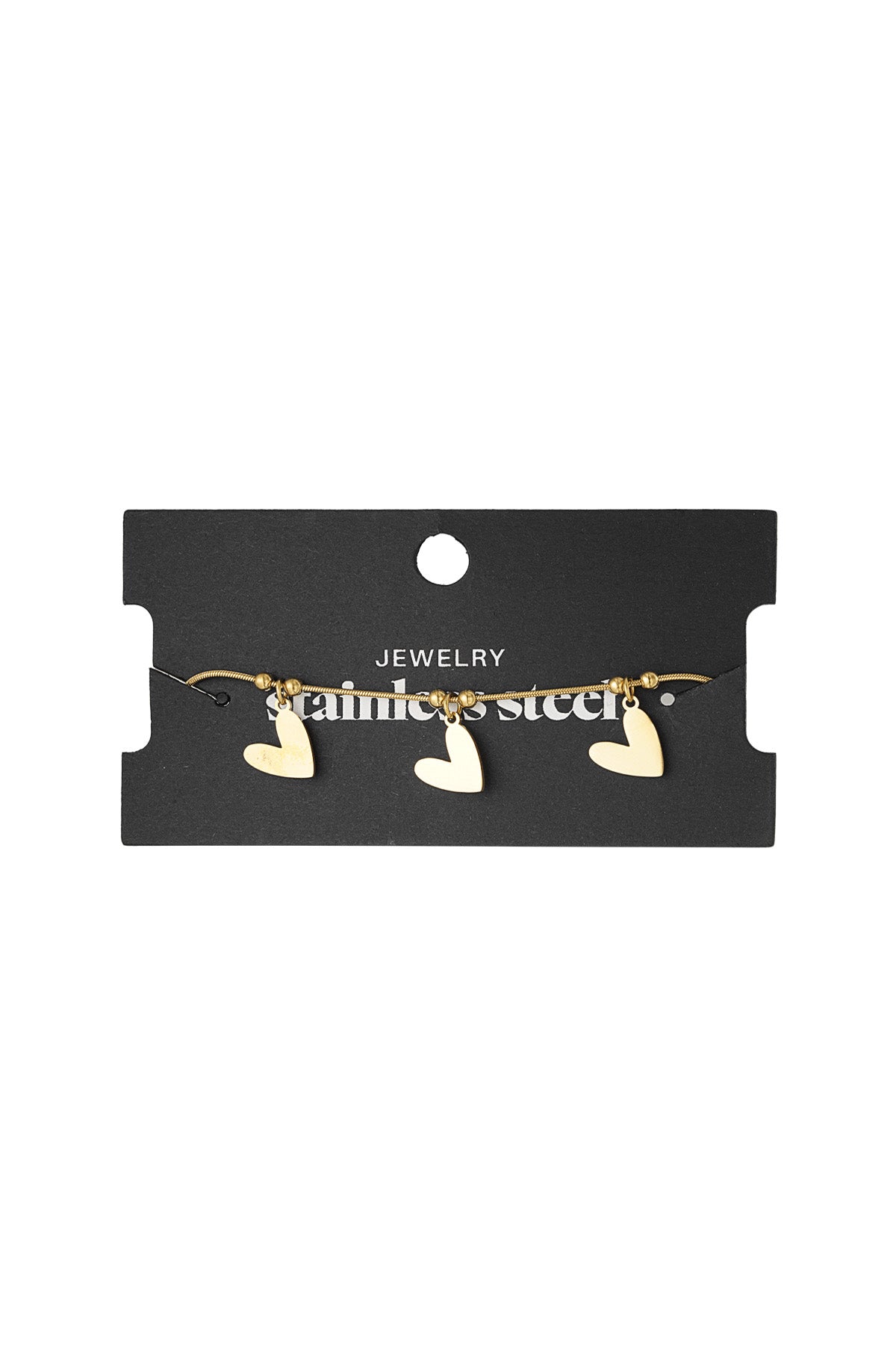 Gold heart charm bracelet displayed on black jewelry card with stainless steel label