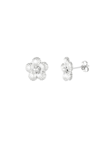 Silver fluted flower stud earrings shown on white background