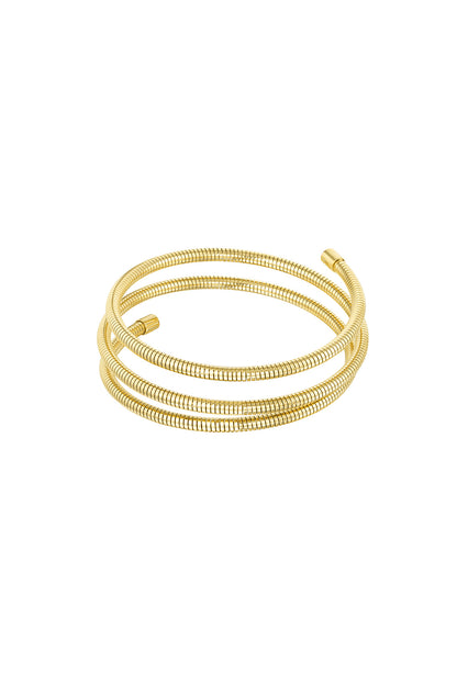 Gold spiral coil cuff bracelet with three flexible loops isolated on white background