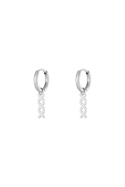 Pair of silver geometric hoop drop earrings with the same interlocking X pendant on a white background