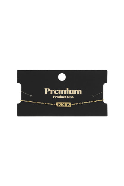 Triple X minimalist bracelet displayed on black Premium Product Line card, gold finish with chain held in place