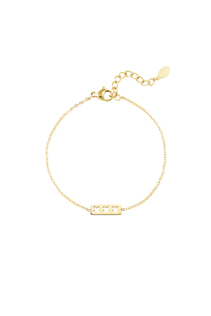 Close-up image of a gold triple X minimalist bracelet with adjustable chain and lobster clasp on white background