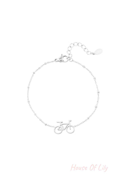 Silver bicycle charm bracelet with delicate beaded chain and extender clasp on white background