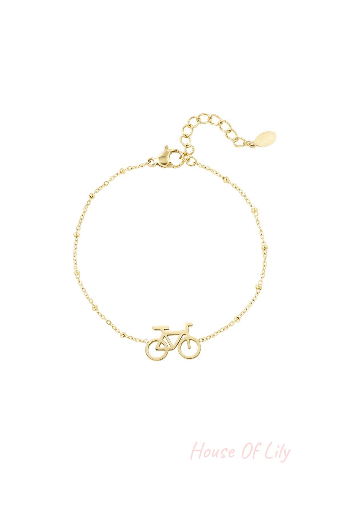 Gold bicycle charm bracelet with delicate beaded chain and extender clasp on white background