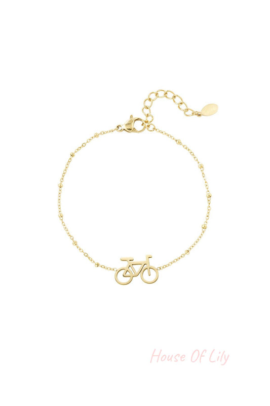 Gold bicycle charm bracelet with delicate beaded chain and extender clasp on white background