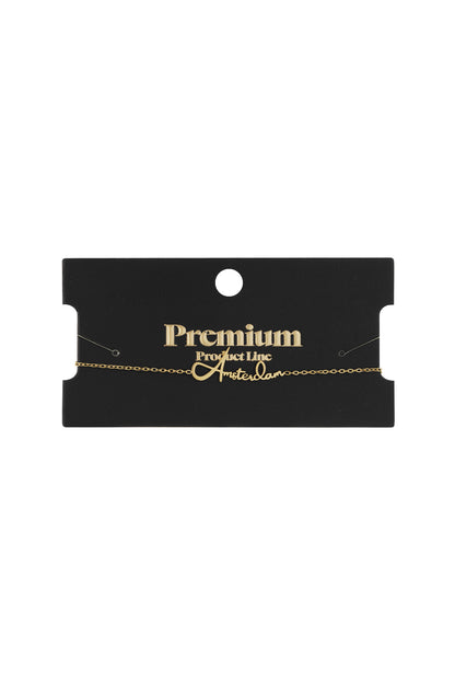 Gold Amsterdam Script Bracelet displayed on black premium product packaging