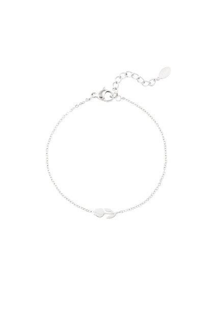 Silver tulip charm bracelet with chain extender and lobster clasp on a plain white background