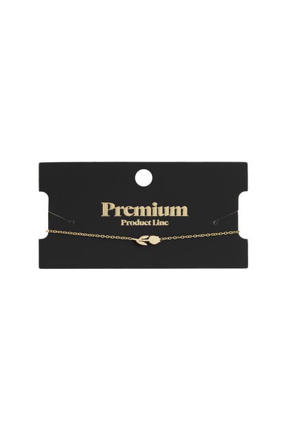 Gold tulip charm bracelet displayed on a black packaging card labelled Premium Product Line