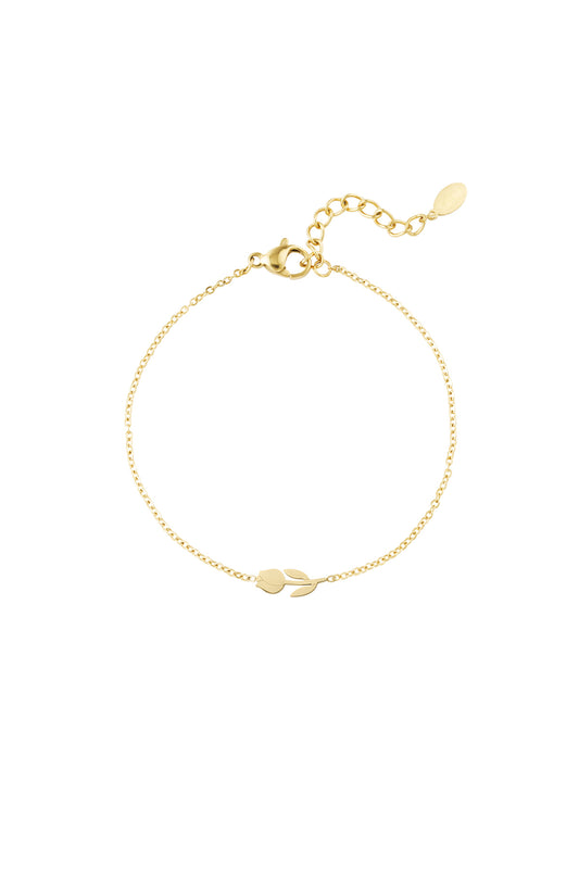 Close-up of a delicate gold tulip charm bracelet with chain extender and lobster clasp on white background