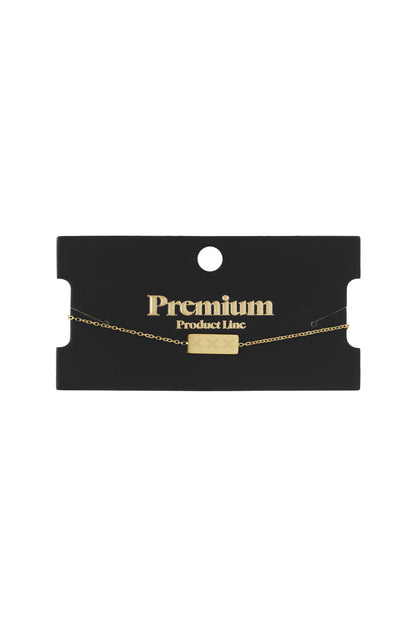 Gold triple X bracelet displayed on black Premium Product Line card