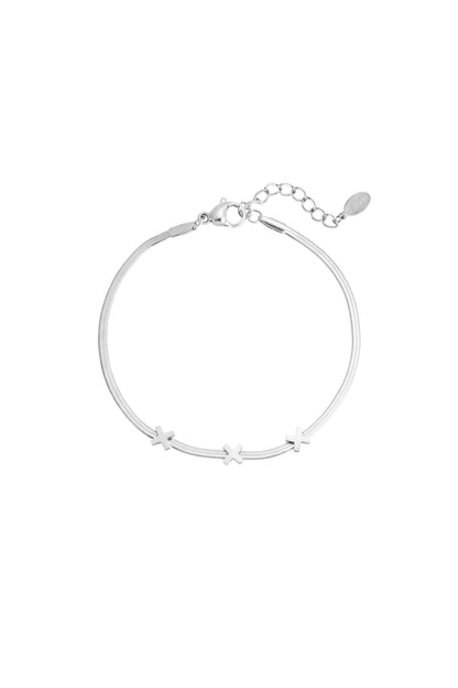 Silver triple X charm bracelet with smooth chain and lobster clasp on white background