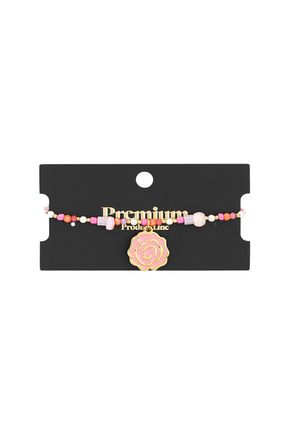 Beaded bracelet displayed on black premium product card with rose charm
