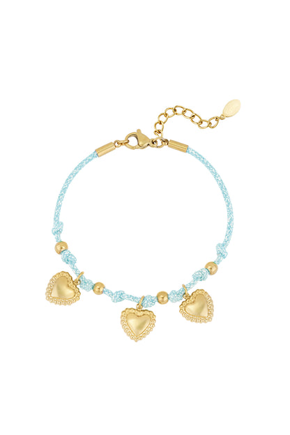 Light blue braided bracelet with gold heart charms displayed on white background