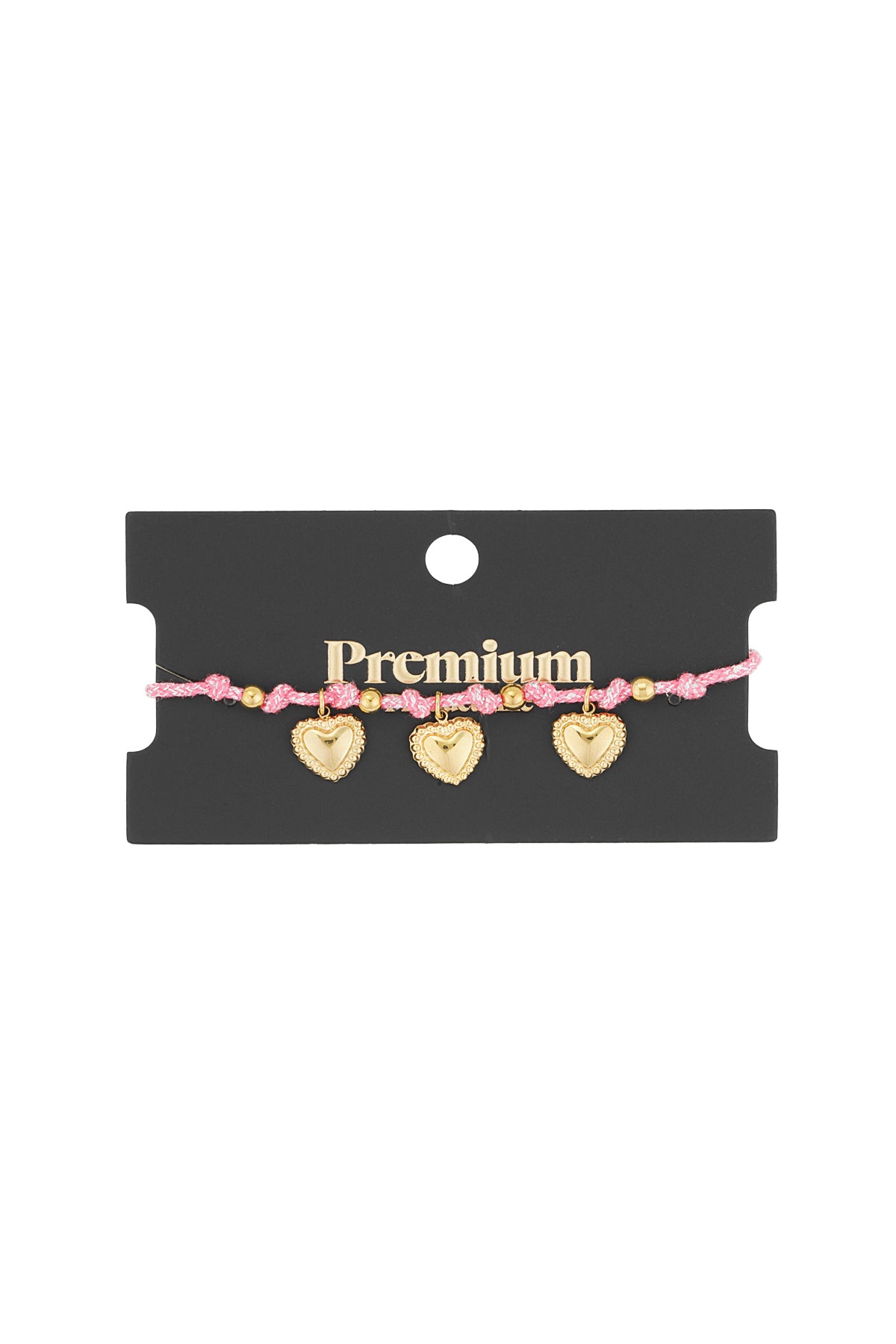 Pink braided bracelet with three gold heart charms on a black retail card labeled Premium