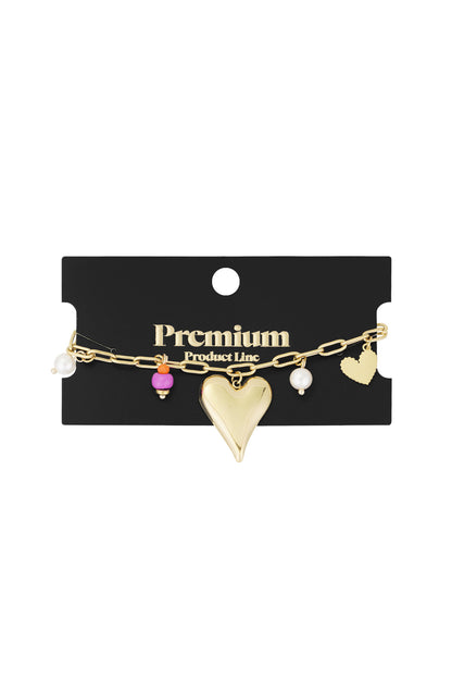 Gold-tone charm bracelet displayed on black premium product card highlighting elegant presentation