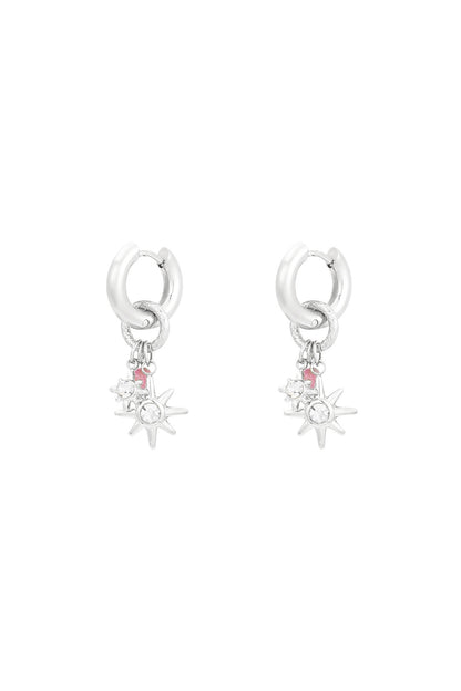 Silver-tone starlight charm hoop earrings with clear rhinestone stars on white background