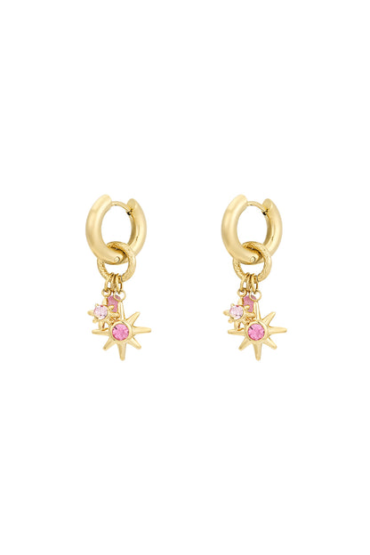 Gold-tone starlight charm hoop earrings with pink rhinestone stars on white background