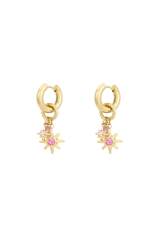 Gold-tone starlight charm hoop earrings with pink rhinestone stars on white background