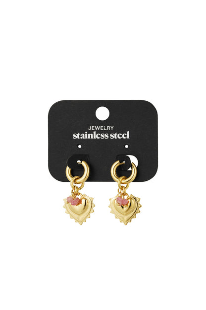 Gold heart charm earrings displayed on a black stainless steel jewellery holder card
