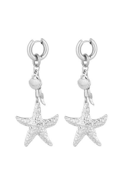 Pair of silver-tone hammered starfish and seashell drop earrings on white background